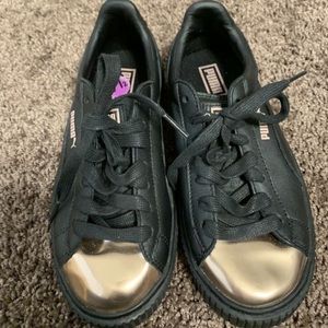 Black and gold leather platform pumas